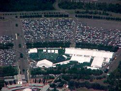An overhead view of the main stage and stands outside the gates of EPCOT and the tents housing the pits and other playing fields deeper into the parking lot [11]