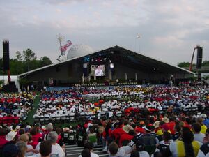 Dean Kamen speaking on the big stage with Spaceship Earth in the background[11]