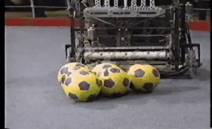 Team -105 picks up a cluster of balls in finals match one at the 1994 FIRST Robotics Competition [4]