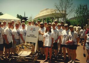Team 171 with robot and robot crossing sign [5]