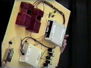 The receiver box (lower middle) and relay box (upper right), with RNET radio, servos, limit switches, and two drill motor battery boxes [6]