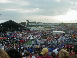 A monorail passing the stands and crowd [21]