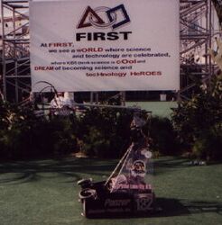 Team 132's robot in front of the FIRST banner [3]
