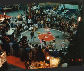 Getting ready for a match at the first Canada FIRST event. Other robotics and hobbyist competitions like Micromouse can be seen in the background. [1]