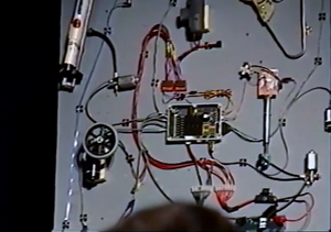 The BASIC Stamp controller (center) with Tekin speed controllers and several motors included in the kit [4]