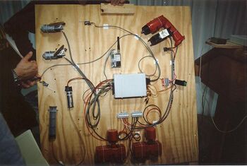 The receiver and relay box (center), with RNET radio (above), drill motor and cooling fan (upper right) and Tekin speed controller (right), batteries and battery holders (below), pneumatic pump (lower left), and Delco seat motors (upper left) [12]